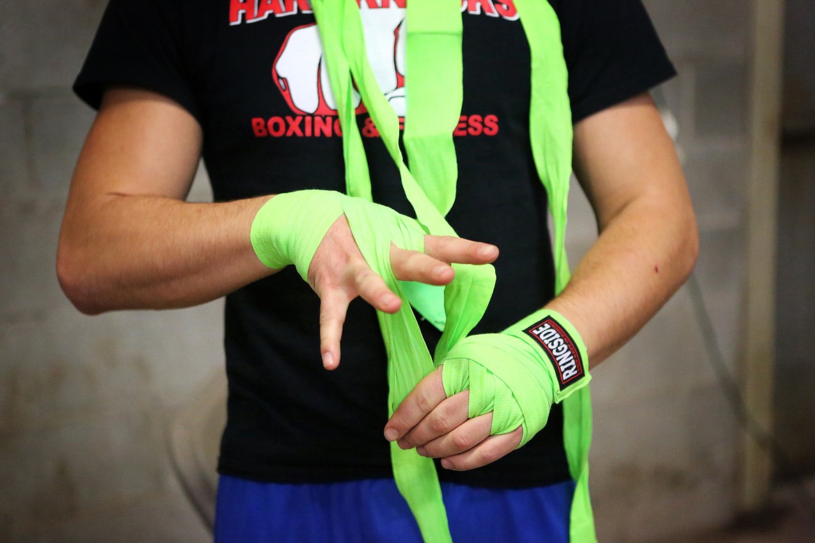 Taylor Reed wraps his hands prior to an Oct. 28 fight against Marshall Sutherland in Kalispell.