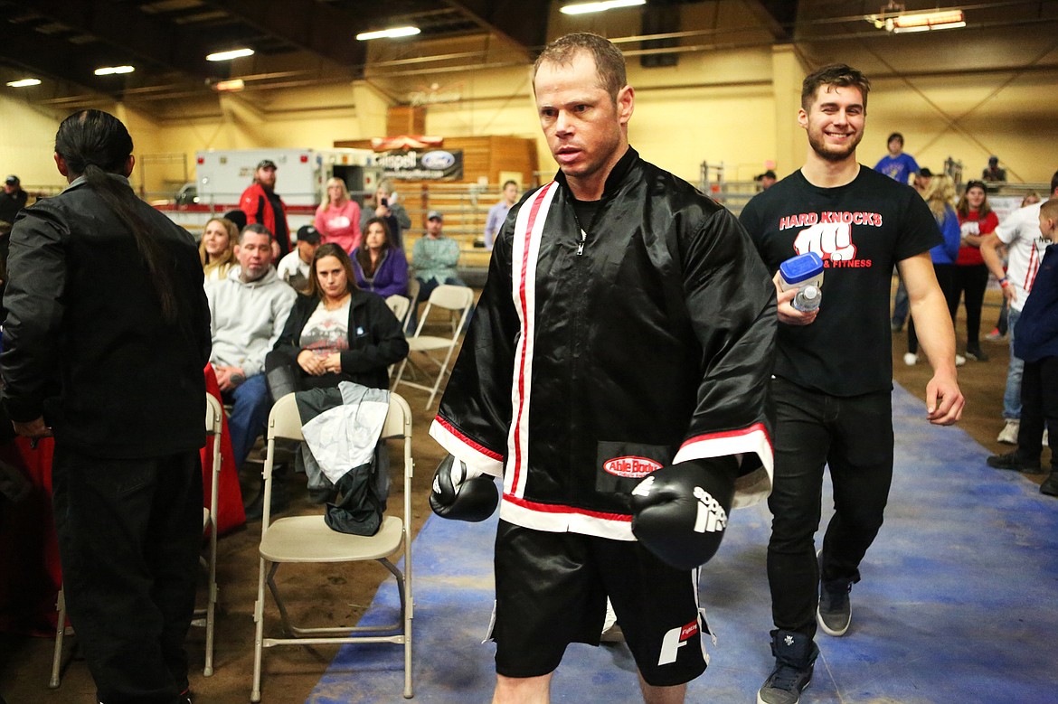 Pro boxer Jesse Uhde, of Evergreen, makes his way to the ring where he faced off against Jacbo Ruffin, with Taylor Reed following close behind. Uhde won the match unanimously. (Mackenzie Reiss/Daily Inter Lake)