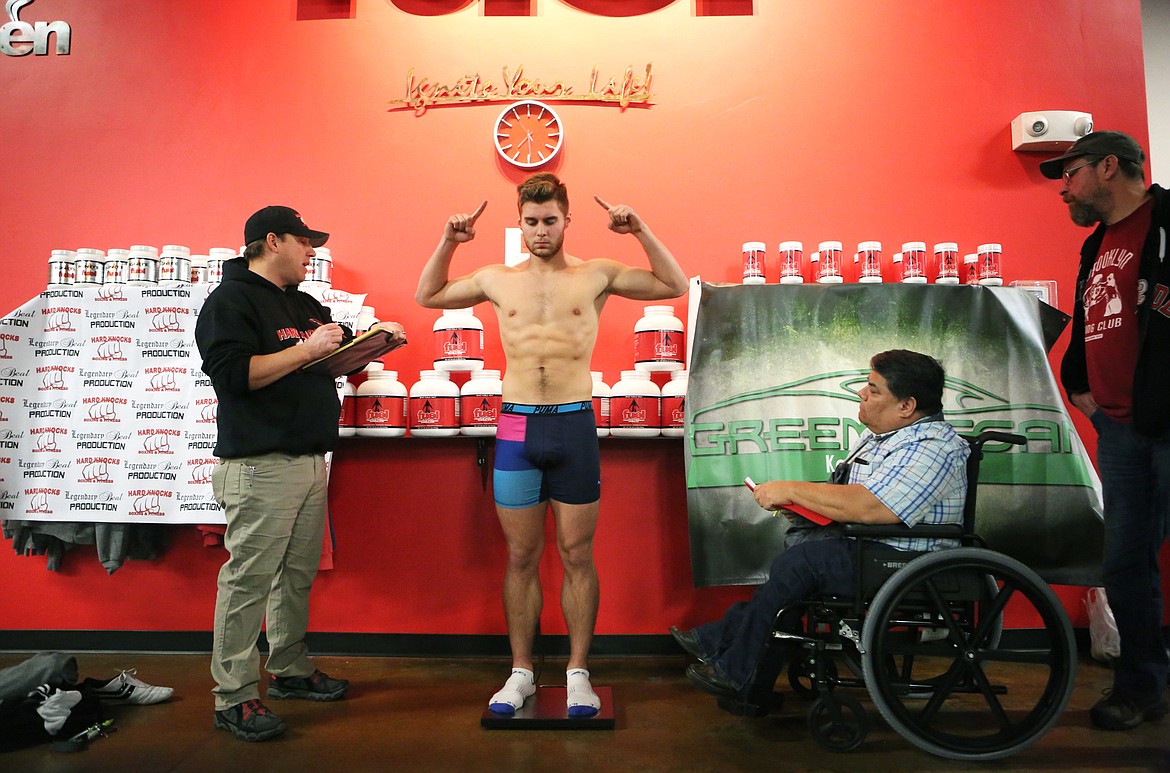 Taylor Reed weighs in at 179 pounds during the official weigh-in at Fuel Fitness in Kalispell the night before Fight Night 6. To make weight, most fighters cut their water weight in the days leading up to weigh-in, and then rehydrate before their fight. (Mackenzie Reiss/Daily Inter Lake)