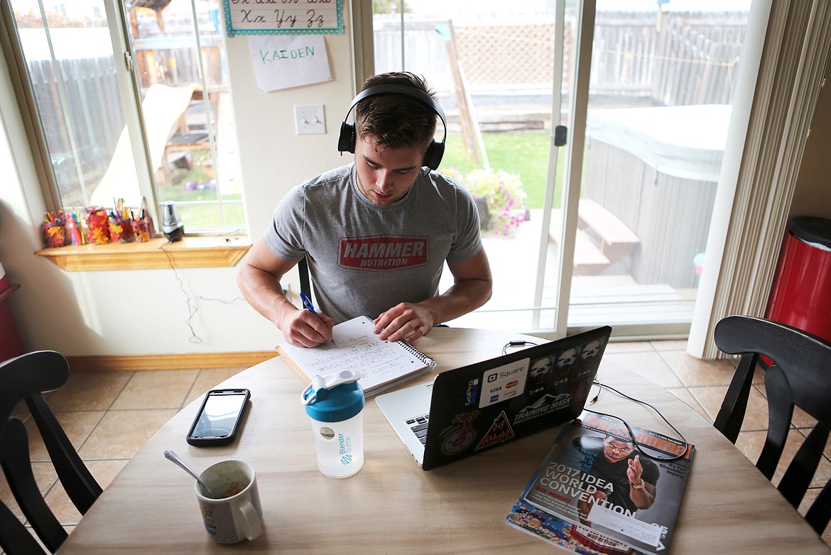 Reed takes notes while watching videos of other boxers at his Kalispell home. Reed spends one to two hours each day watching fights as part of his training.