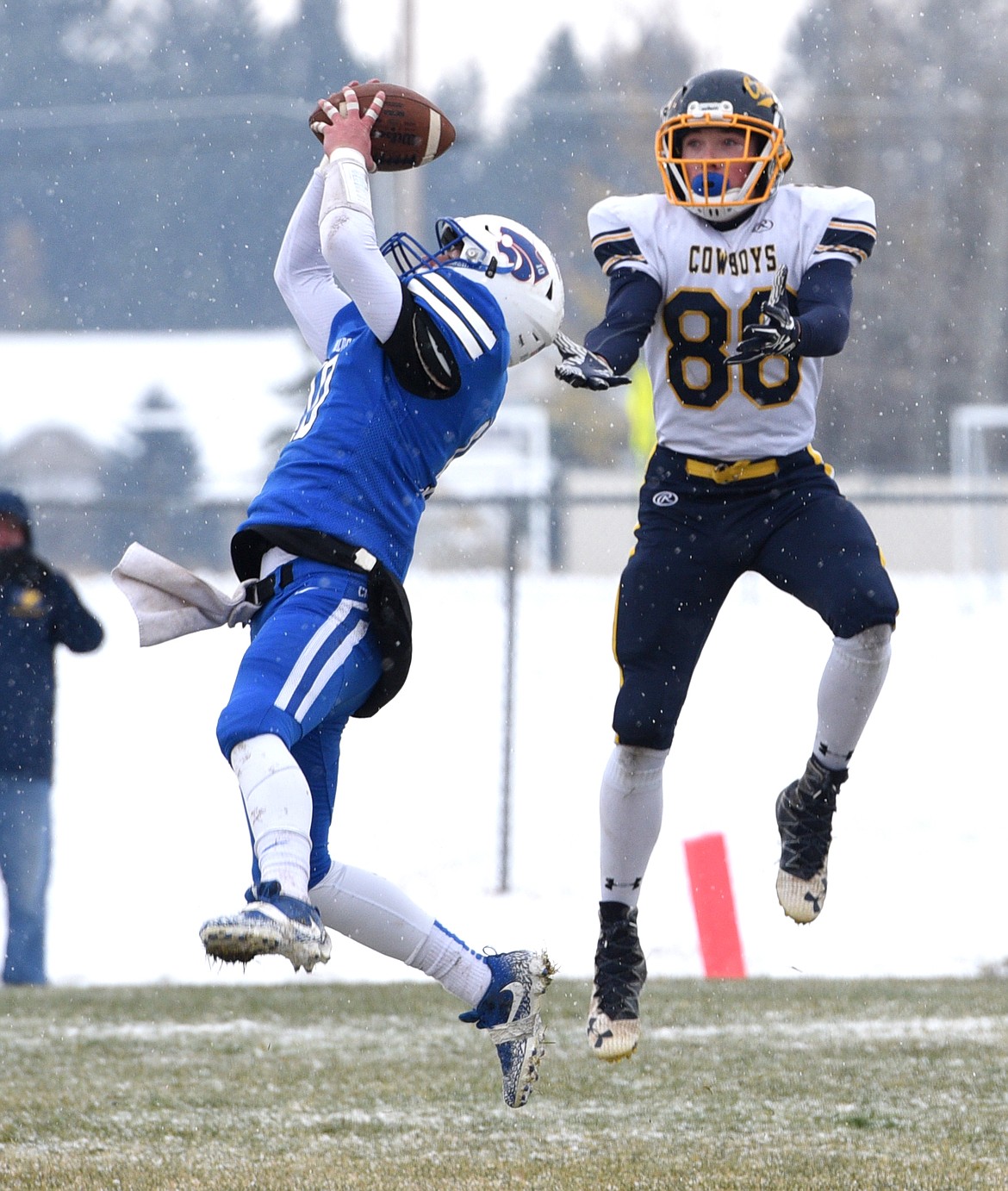 Columbia Falls defensive back Austin Green leaps in front of Miles City tight end Kon Speelmon for an interception during the second round of the Class A playoffs on Saturday. (Aaric Bryan/Daily Inter Lake)