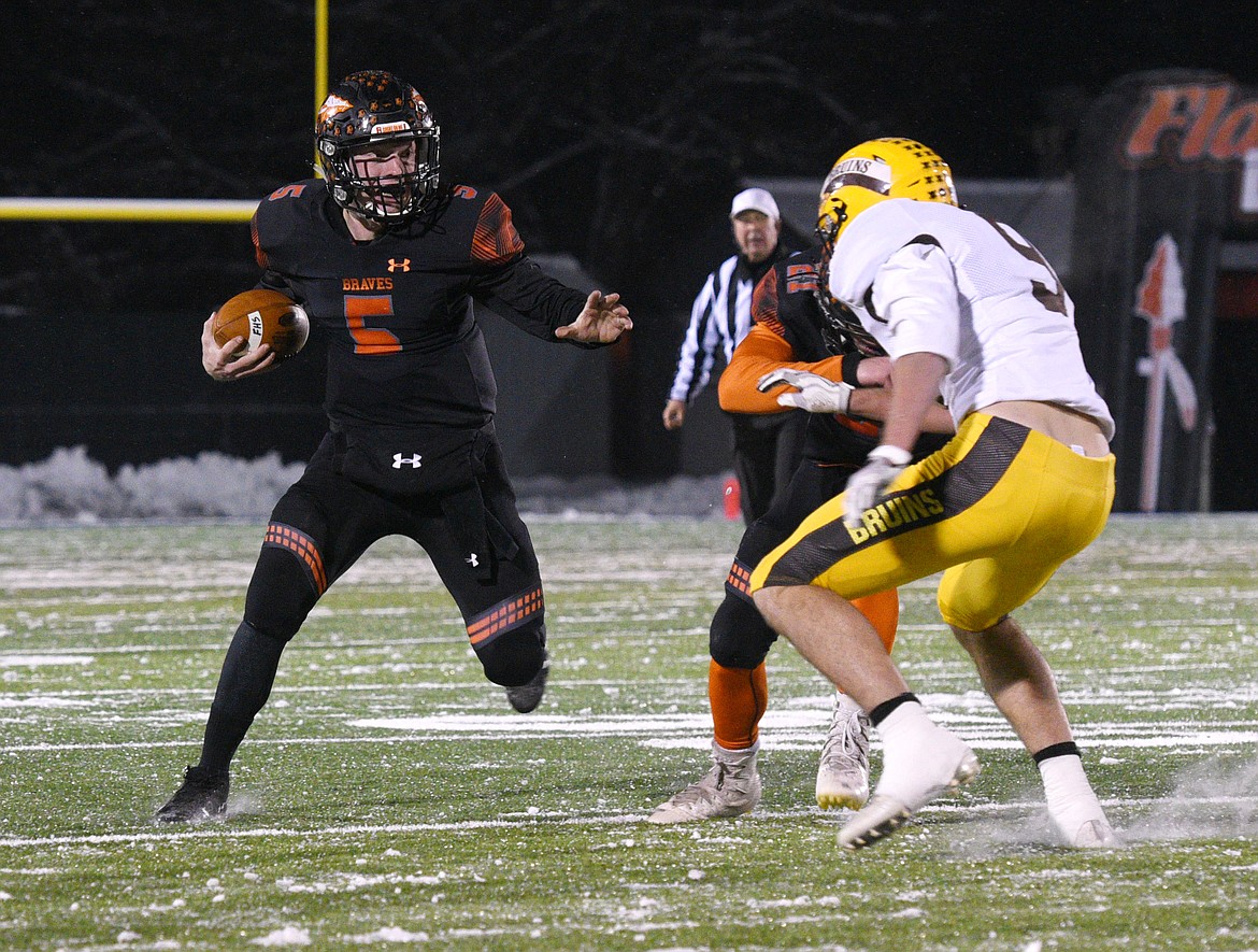 Flathead quarterback Taylor Morton waits for a block during a long run against Helena Capital on Friday. (Aaric Bryan/Daily Inter Lake)