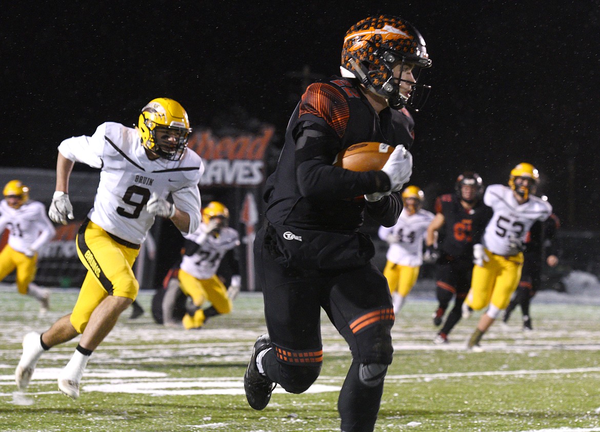Flathead running back Jonathan Baker speeds down the sideline after hauling in a pass against Helena Capital in the second quarter at Legends Stadium on Friday. (Aaric Bryan/Daily Inter Lake)
