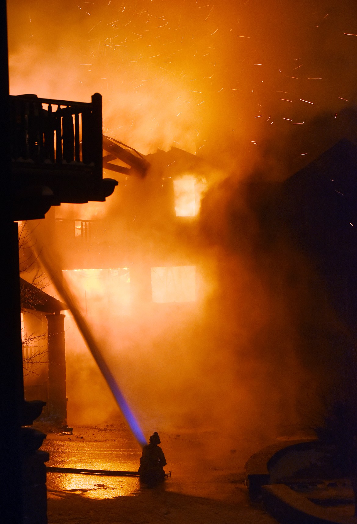 Fire crews battle a blaze at a townhouse on Slopeside Drive on Big Mountain Thursday night. (Brenda Ahearn/Daily Inter Lake)
