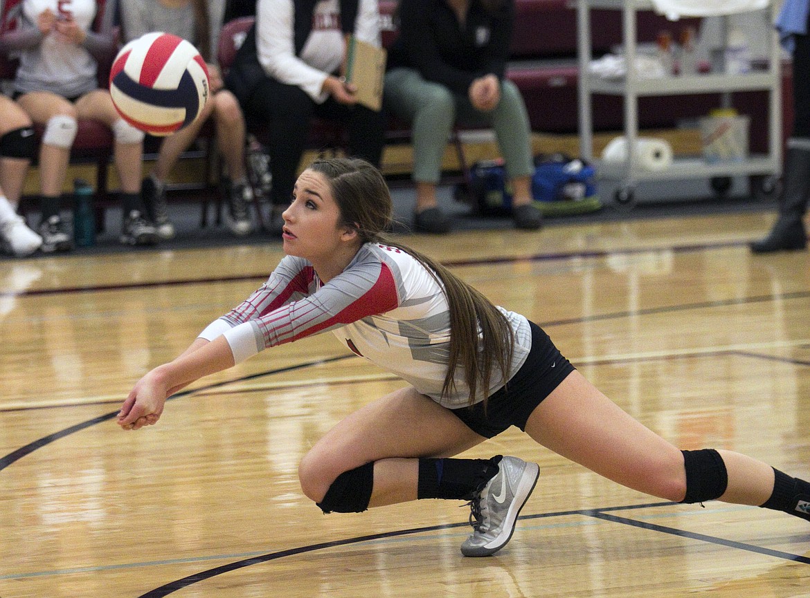 ARLEE SCARLET Eden Morin digs a Gardiner attack during the Western Class C Divisional Tournament Friday at Manhattan Christian High School. (photo courtesy of Neil Patrick Healy, Livingston Enterprise)