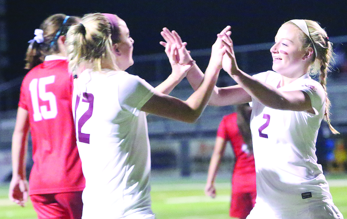 Connor Vanderweyst/Columbia Basin Herald
Moses Lake's Morgan Skone (12) and teammate Madi Krogh celebrate Krogh's goal in the 78th minute against Eastmont.