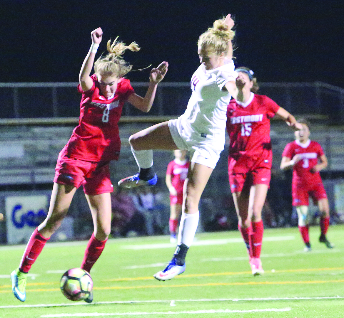 Connor Vanderweyst/Columbia Basin Herald
Moses Lake defender Cora Bruneel (right) contests the ball next to Eastmont's Alyssa Konarek.