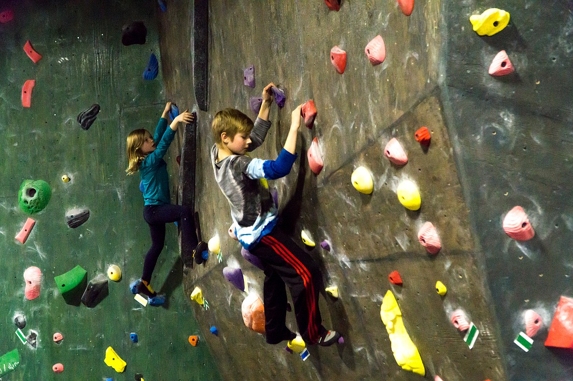 Two young climbers practice traversing.