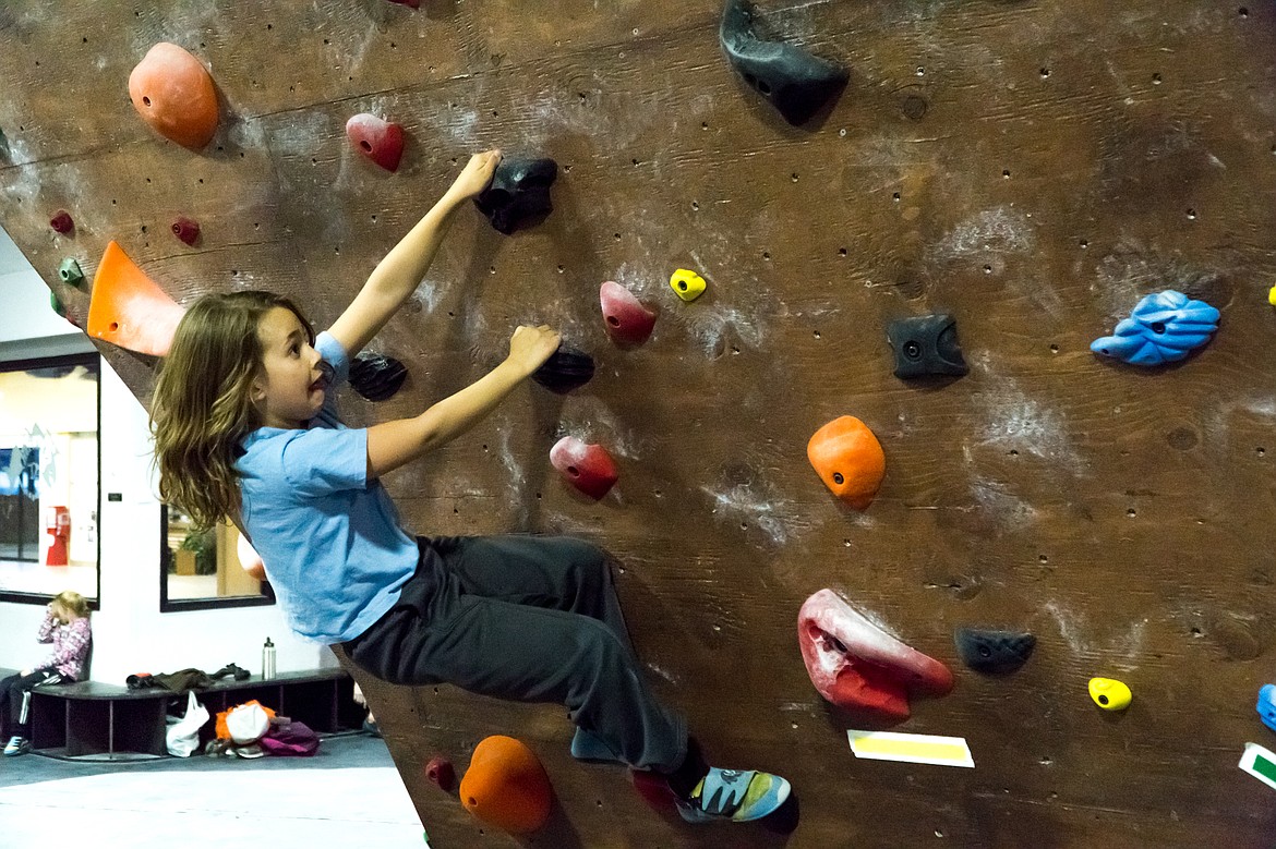 A young &#145;Scaler&#146; reaches for a hold at the Rockfish bouldering gym.