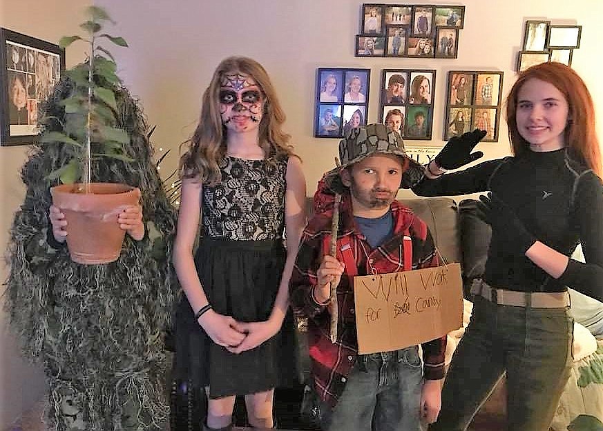 A Sneaky Sniper, Sugar Skull Skeleton, Hobo and Kim Possible get ready to nab some treats in Superior. (Photo by Kami Hill Milender)