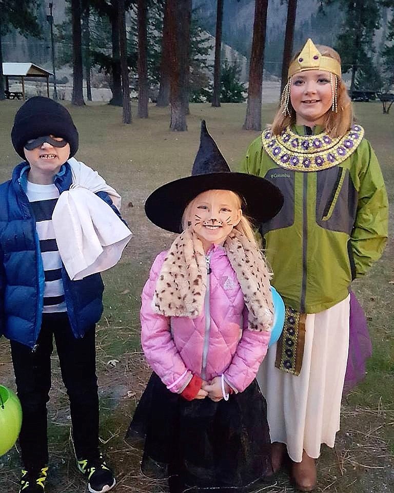 A Burglar, Cat Witch and Cleopatra start their search for sweet treats down streets and alleys. (Photo by Kate Digiando)