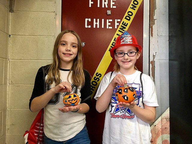 Sisters Aubrey and Aliyah Birdsell cashed in on winning the pumpkin painting contest by getting to ride in a fire engine to school on Halloween. Firefighters picked up the sisters outside of Wallace and gave them a ride to Silver Hills Elementary. Fire crews arrived with lights flashing for pick up and drop off!