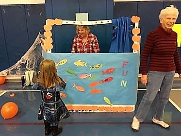 Missy and Sylvia Neu ran the fishing booth at the Superior Girl Scouts Troop 3802 Halloween Carnival held on Oct. 28 at the elementary school gym. (Photo courtesy of Whitney Neu)