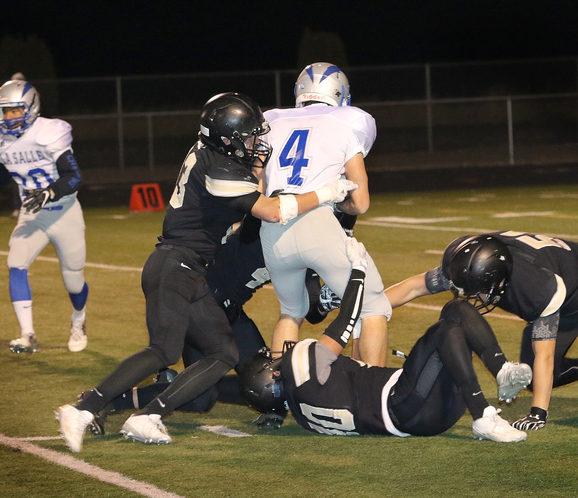 Pete Christensen photo - A host of Knights bring down the Lightning's wide receiver Patrick Kelly.