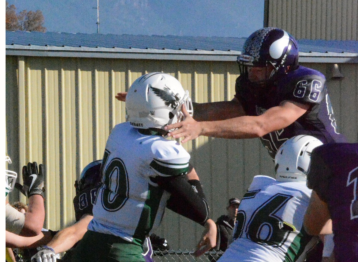 CHARLO DEFENSIVE TACKLE Brock Brock Tomlin applies pressure to Joliet quarterback Taylor Rowlison in the first round of the MHSA Class C, 8-man playoffs Saturday at Charlo High School. (Jason Blasco/Lake County Leader)