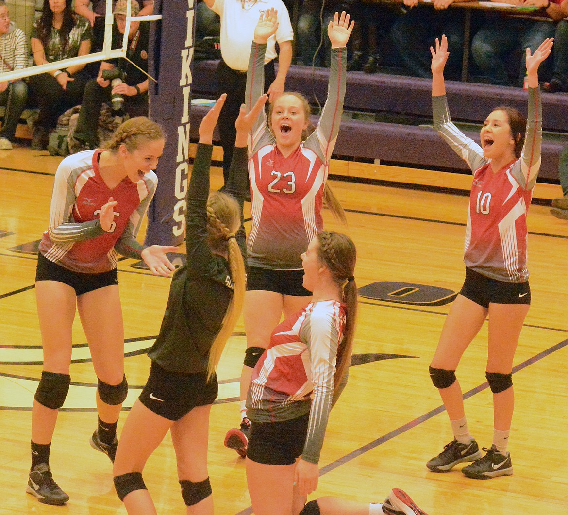 THE ARLEE Scarlets volleyball team celebrates after qualifying for divisionals with crucial victories over Charlo and Plains the District volelyball tournament Thursday and Friday at Charlo High School. (Jason Blasco/Lake County Leader)