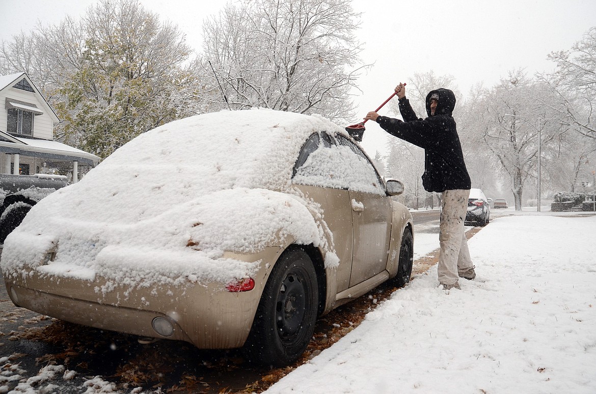 Jeff Russell clears snow from a vehicle on Fourth Avenue East in Kalispell on Wednesday. The National Weather Service has issued a winter weather watch through Friday for the area. Total snow accumulations of 4 to 8 inches, with localized amounts up to 9 inches, are possible. (Matt Baldwin photos/Daily Inter Lake)