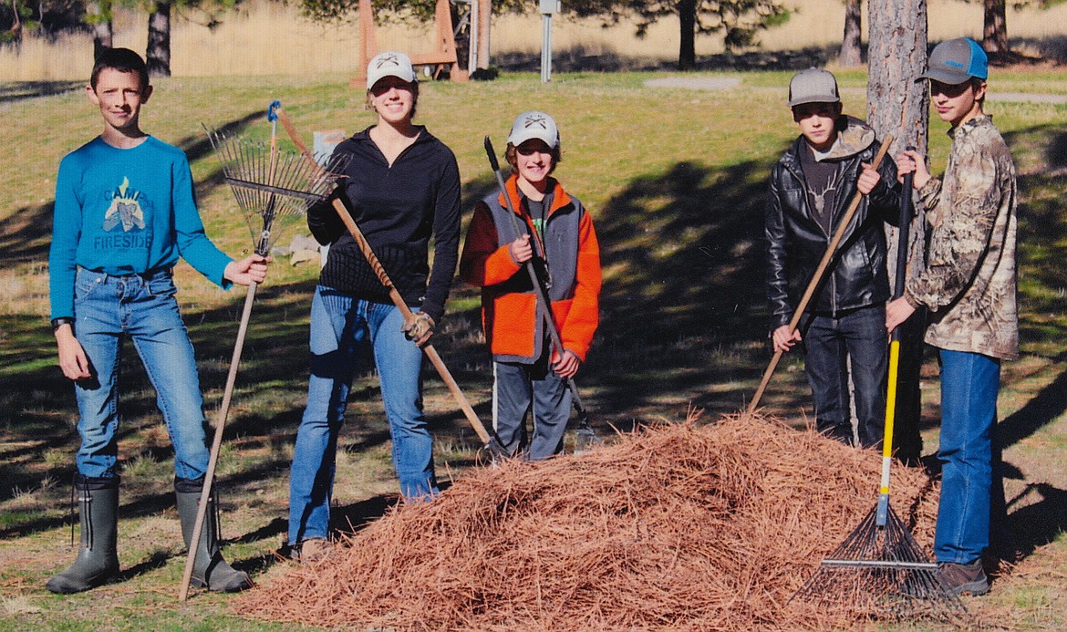 From left to right, Martin Wrobleski, Tressa Lyscio, Tyler Lyscio, Austin Hansen, Cody Hansen rake up pine needles at the Trap Club. (photo supplied)