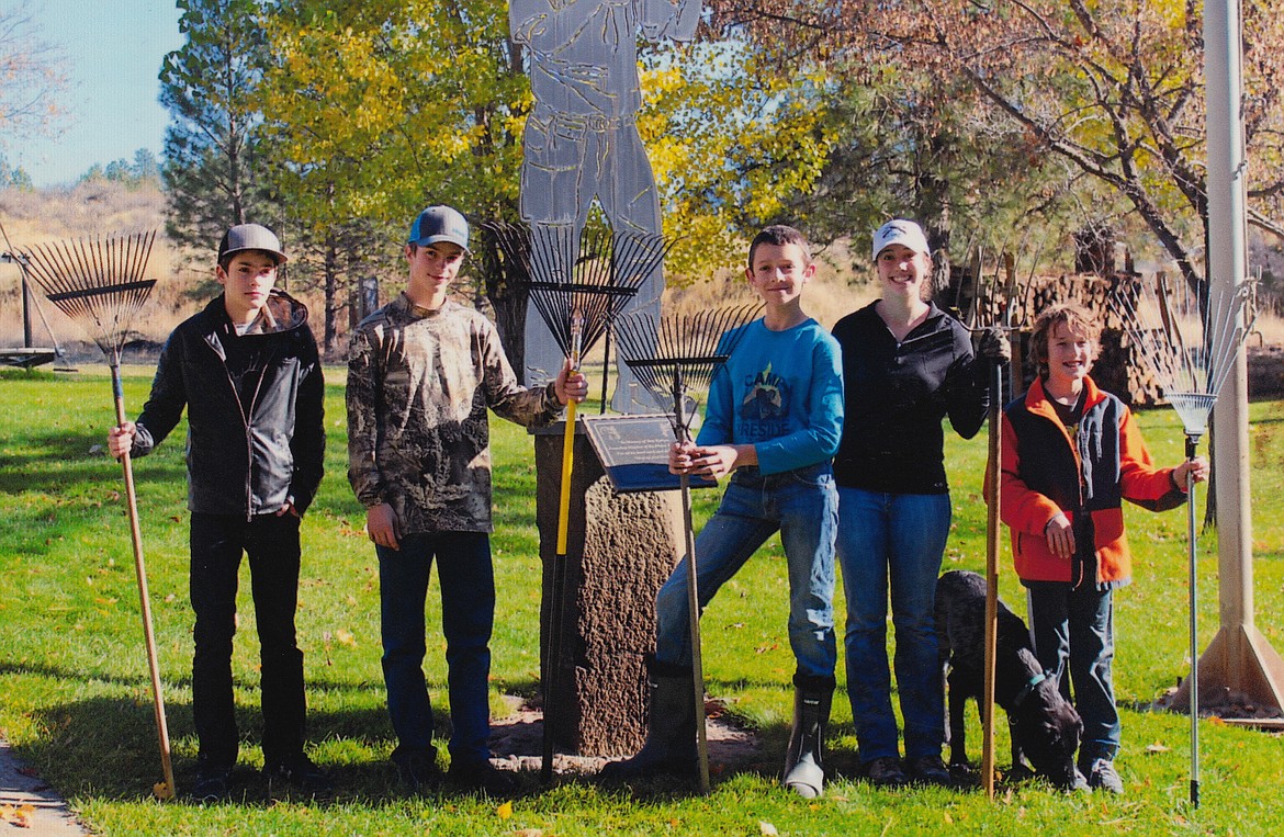 From left to right, Austin Hansen, Cody Hansen, Martin Wrobleski, Tressa Lyscio, Tyler Lyscio in front of the Trap Club statue after a job well done. (Erin Jusseaume/ Clark Fork Valley Press)