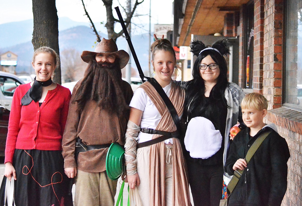 A group of trick or treaters go from shop to shop before hitting the streets of town.