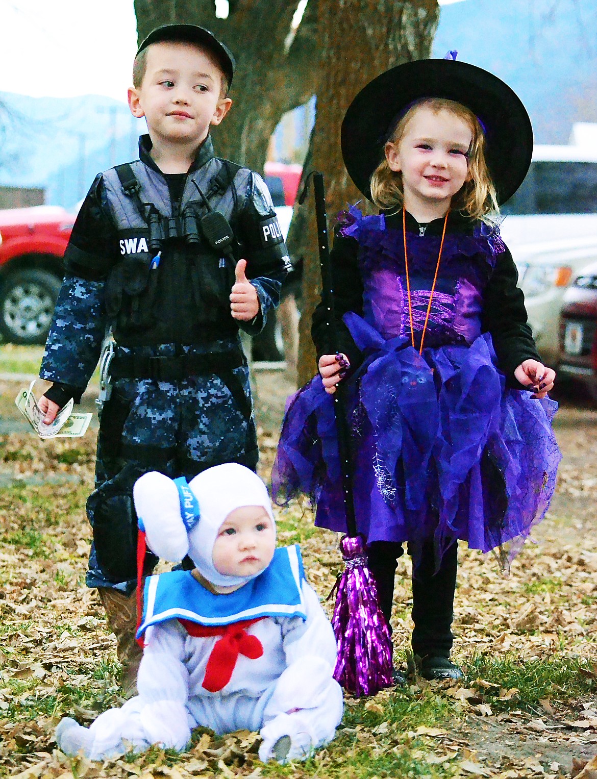 Winners from the Lions Halloween costume contest on Halloween. (L-R) Ben Turner First place in his S.W.A.T. costume, baby Jeb Browning Second place and Lily Taylor Third place (Erin Juseaume/ Clark Fork Valley Press)