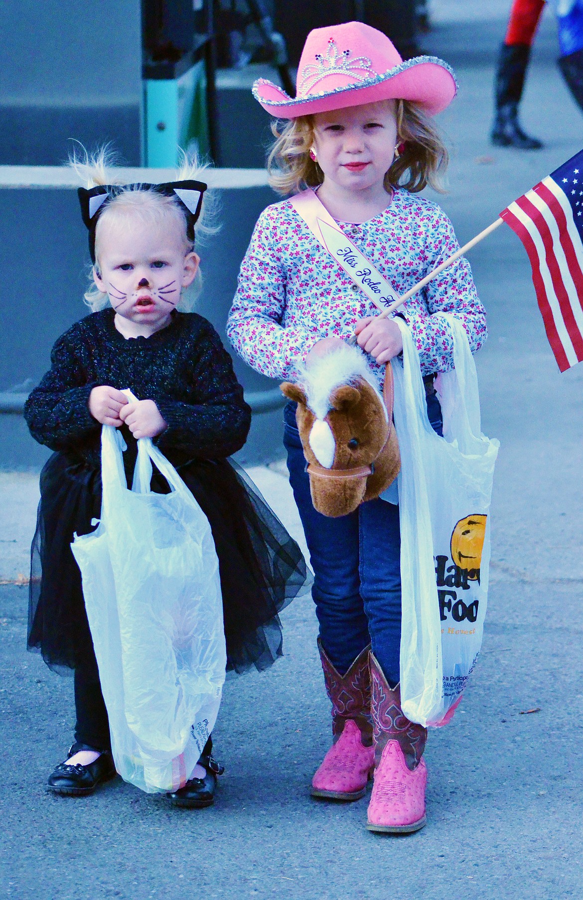 This young rodeo queen was trick or treating with a little cat.