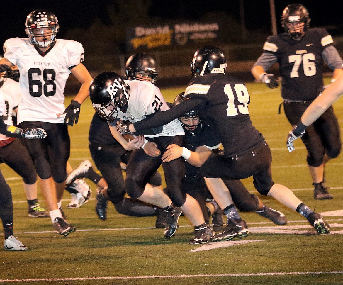 Pete Christensen photo - Ty Miller and Jacob Joslin bring down the Panther running back.