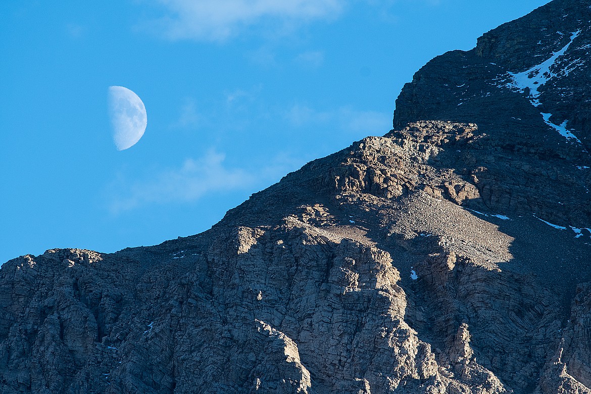 The half moon rises over Mad Wolf Mountain.