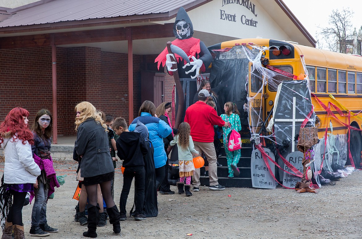 Trick-or-treaters line up for a haunted bus at the trunk-or-treat event in Libby.