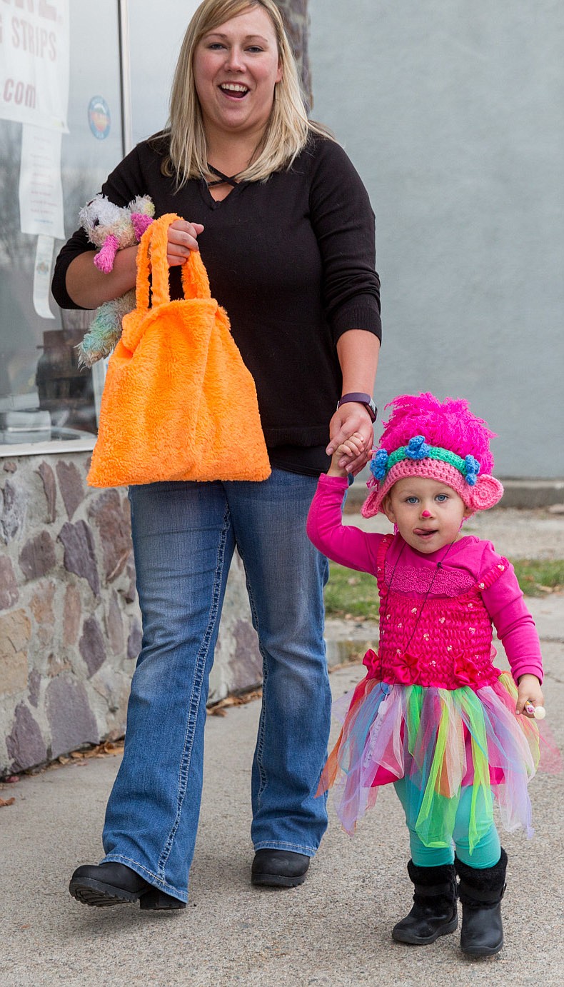 Wendy Lacoss-Drake takes her daughter Emory trick-or-treating along Mineral Avenue Tuesday.