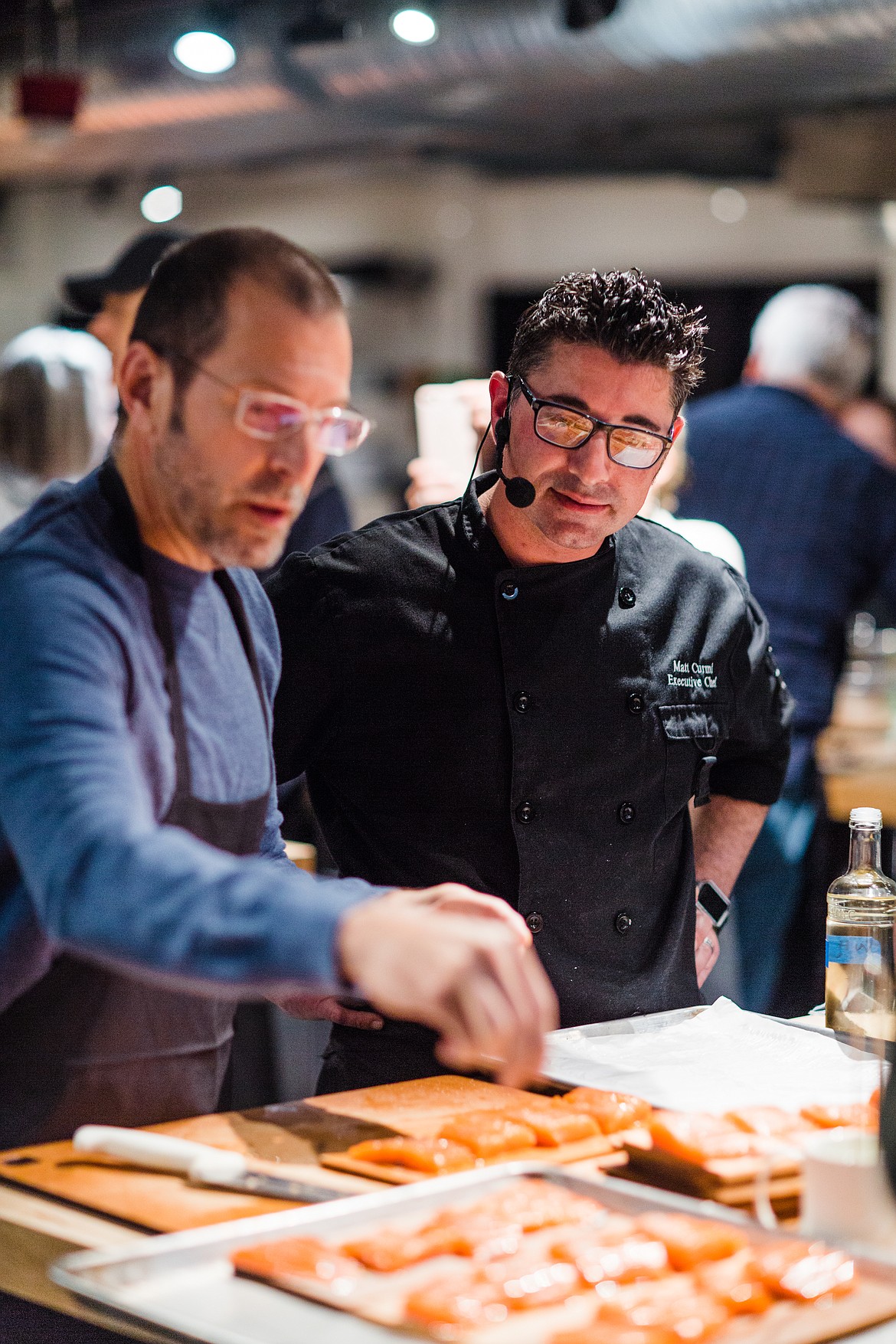 (Photo courtesy WILDWOOD GRILLING)
Wildwood Grilling&#146;s Matt Curmi helps a student at the &#147;Glorious Wood Planked and Smoked Pacific Northwest Dinner&#148; hosted by the Hot Stove Society in Seattle.