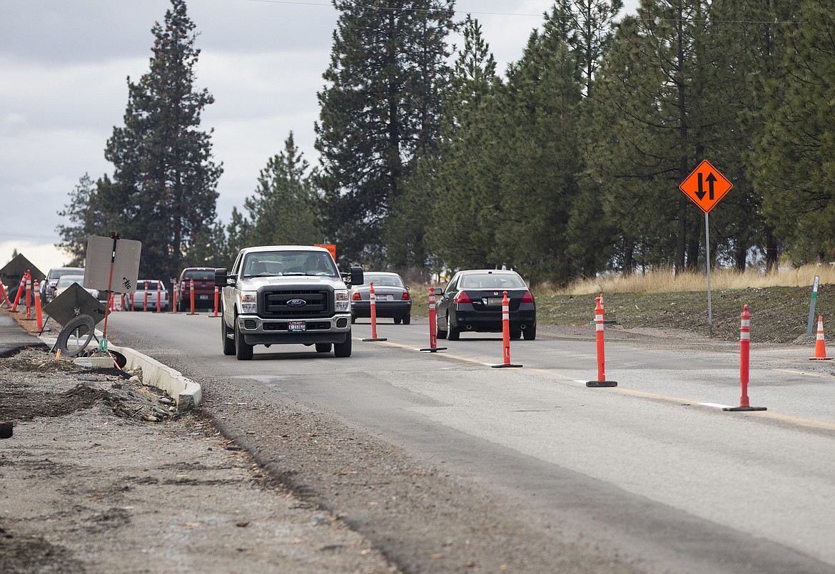 Traffic navigates a single-lane road on Seltice Way on Tuesday. Next spring includes another coating of asphalt and the completion of a pedestrian path on the north side of Seltice Way.