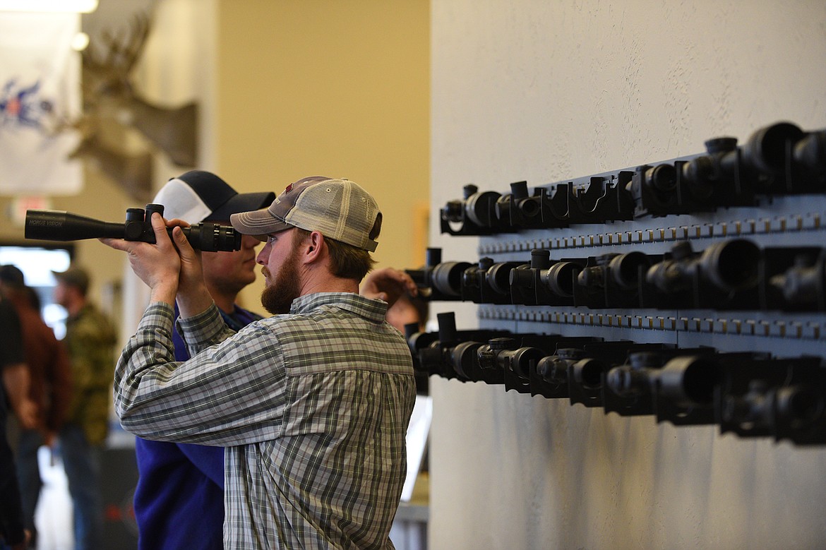 Jim Vincent, of Kalispell, checks out a rifle scope at an open house event at U.S. Optics in Kalispell.