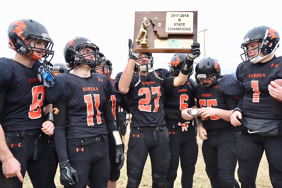 Eureka celebrates with the trophy after defeating Shelby 47-7 in the Class B football state championship game on Saturday at Eureka High School. Eureka beat Shelby 47-7 to capture its second straight state title. (Casey Kreider photo/Daily Inter Lake)