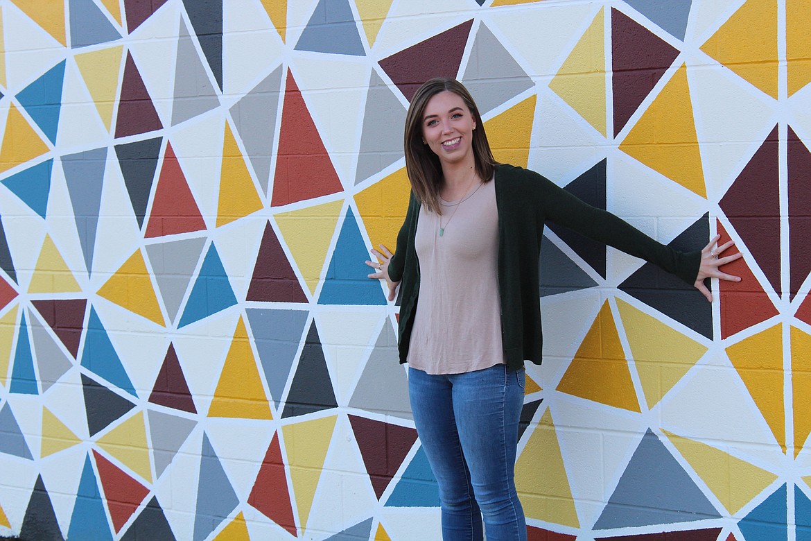 (Photo courtesy DIAMOND KOLOSKI/University of Idaho Argonaut photographer)
UI senior and 2014 Sandpoint High School graduate Danielle Capelli shows off her winning mural last month on the side of Art and Architecture East building at the University of Idaho.