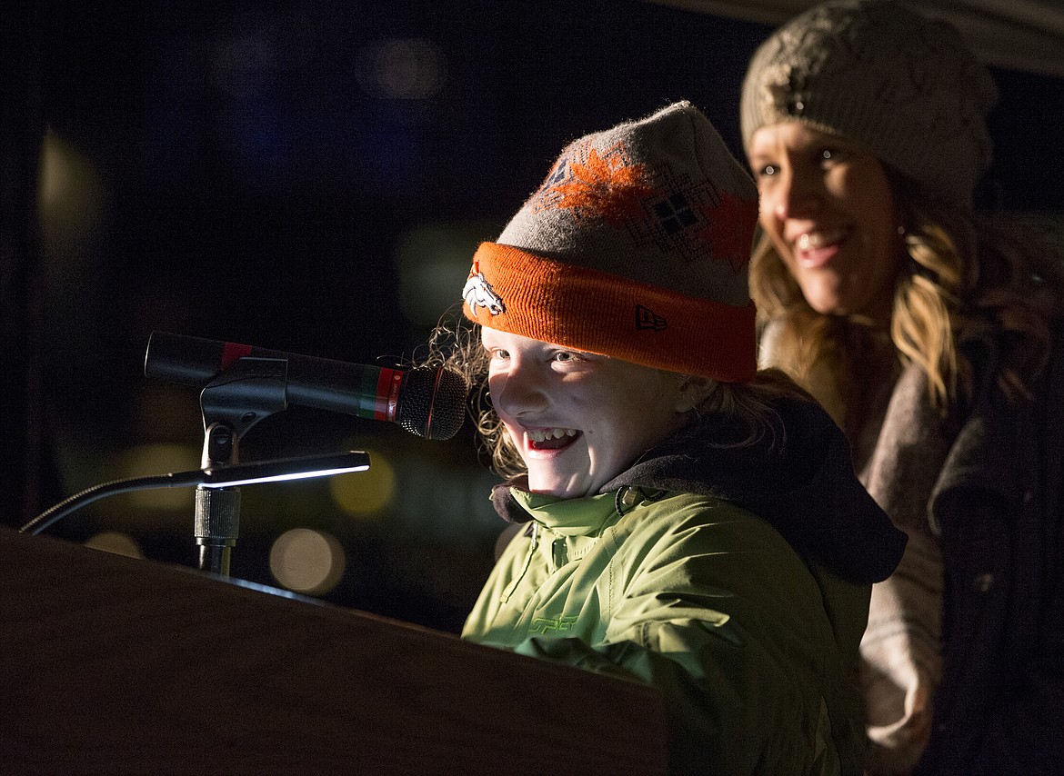 LOREN BENOIT/Press
Standing next to her mother, Lyndsey Neufeld, Hailie Neufeld reads an excerpt about her fight with Type 1 diabetes to a crowd gathered on the lawn of The Coeur d&#146;Alene Resort Monday night at &#147;Light up the Town Blue 2017.&#148;