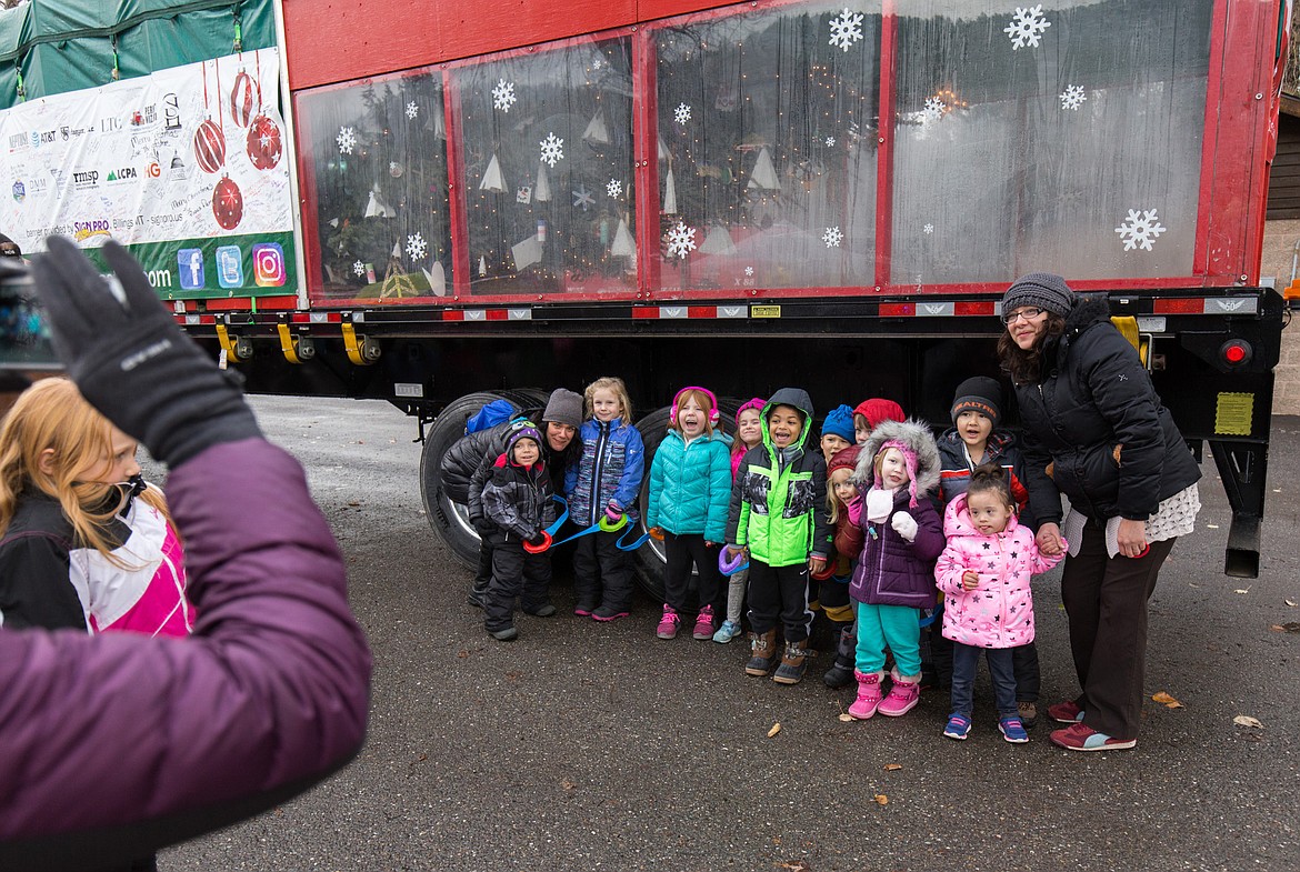 Troy pre-schoolers pose for a photo Tuesday in front of the plexiglass-enclosed tip of the Capitol Christmas Tree. (John Blodgett/The Western News)
