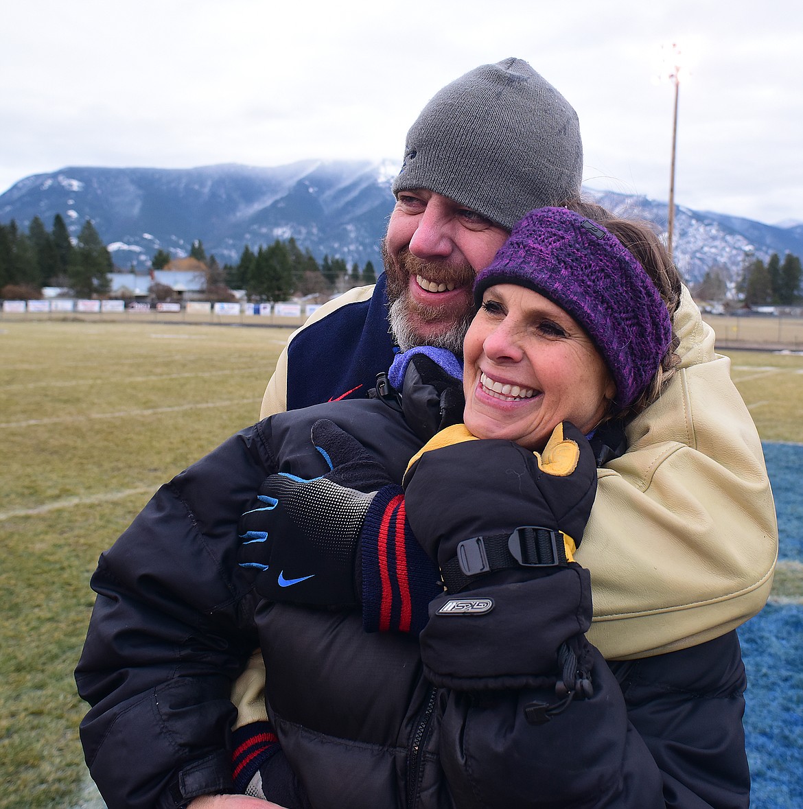 Coach Jaxon Schweikert gives his wife, Suzy a hug after the win.