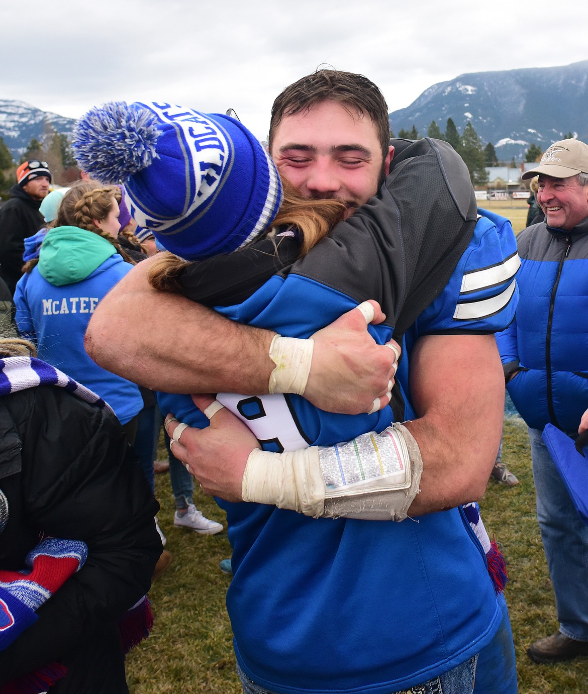 Logan Kolodejchuk gets a big hug after winning the state A championship.