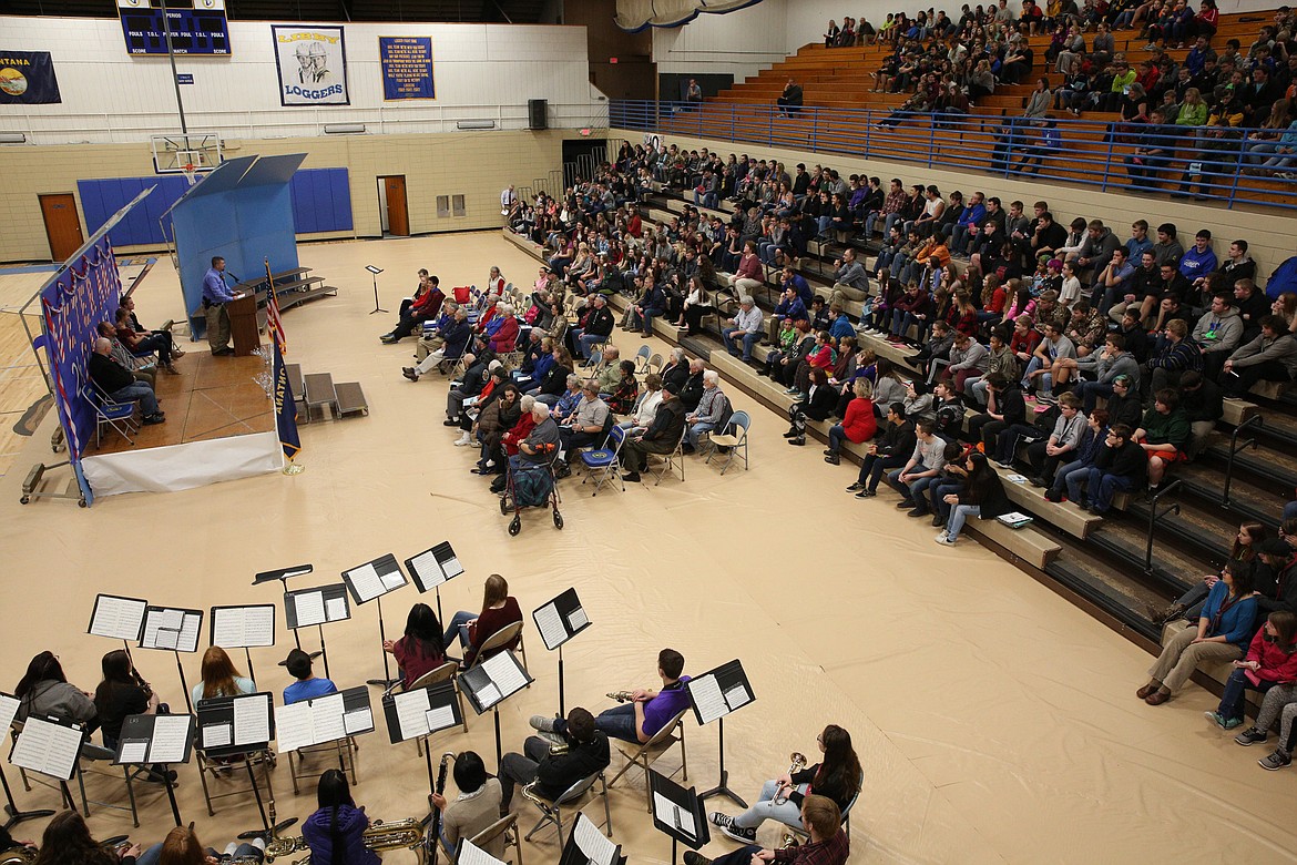 Lincoln County Sheriff Deputy and U.S. Army veteran Brandon Holzer, at the podium, addresses Libby High School students at a Monday morning assembly held in honor of Veterans Day. (John Blodgett/The Western News)