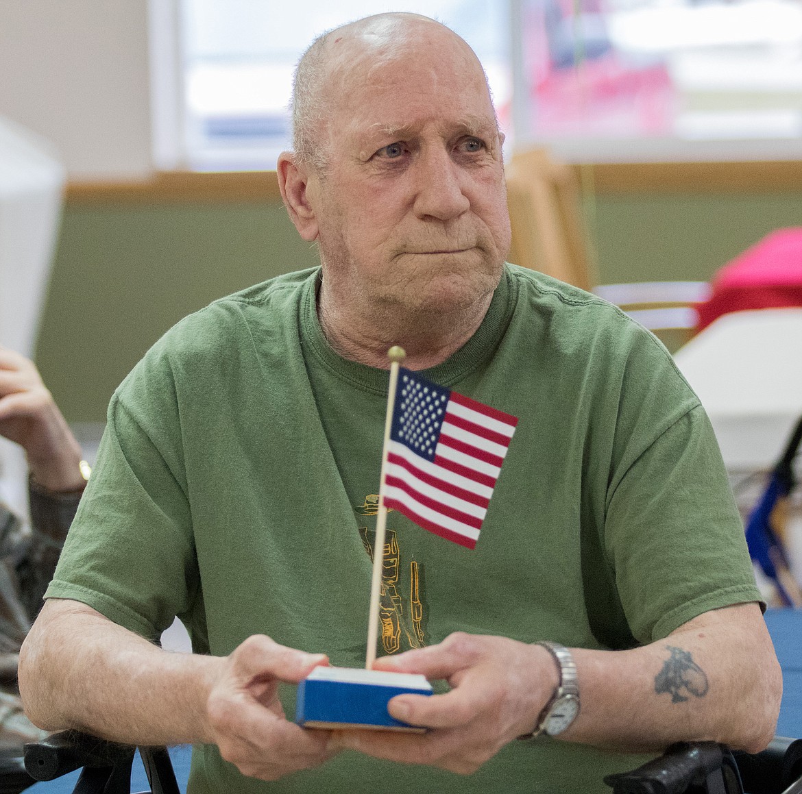 Mike Mills, a Libby Care Center resident, holds a flag honoring his veteran status on Saturday, Nov. 11. Members of Libby VFW Post No. 1548 handed out the handmade memorials to the center&#146;s veterans. (John Blodgett/The Western News)