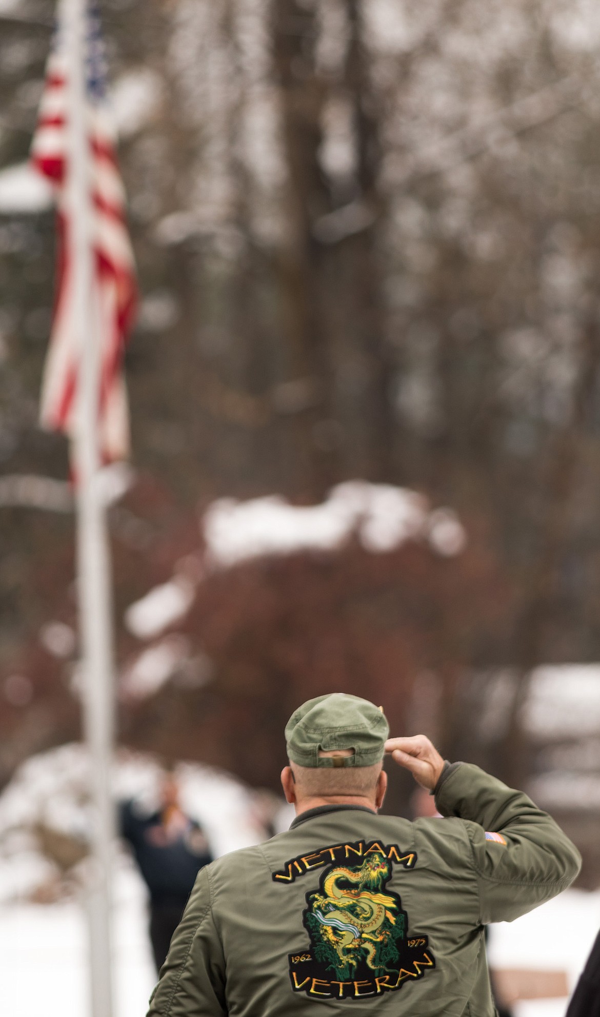 Terry Holthaus of Libby, a 26-year veteran of the U.S. Navy who served in Vietnam, salutes the flag during a Veterans Day memorial service at Libby Cemetery on Saturday, Nov. 11, 2017. (John Blodgett/The Western News)