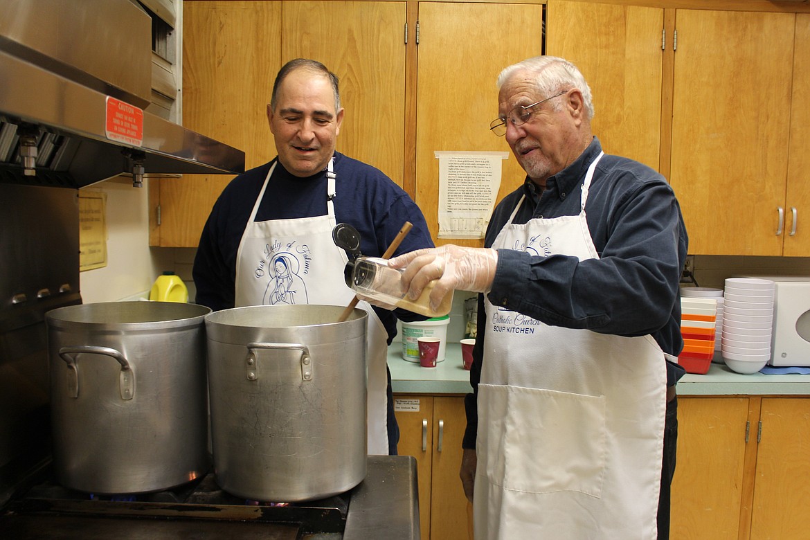 Cheryl Schweizer/Columbia Basin Herald
Volunteer soup chefs Pete Doumit (left) and Clyde Carpenter tweak the chicken soup served at the weekly lunch served at Our Lady of Fatima Catholic Church.