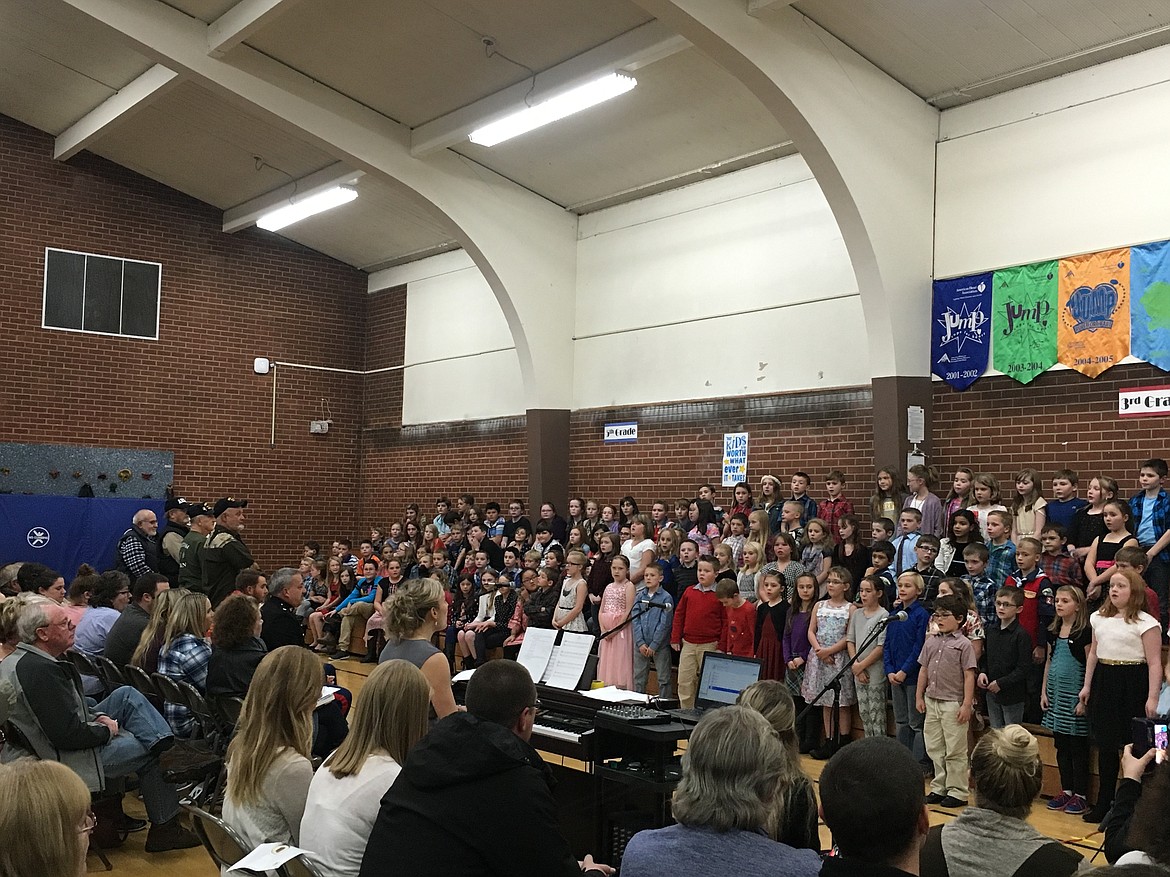 Pinehurst Elementary students sing &#147;The Army Goes Rolling Along&#148; during their Veterans Day assembly last Thursday. Fifth-graders also sang &#147;Marines Hymn.&#148; During each performance, member of the respective branches were asked to stand to be recognized.