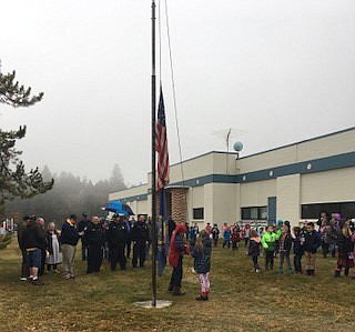 Raising the flag during the Veterans Day celebration at Mt. Hall Elementary School.