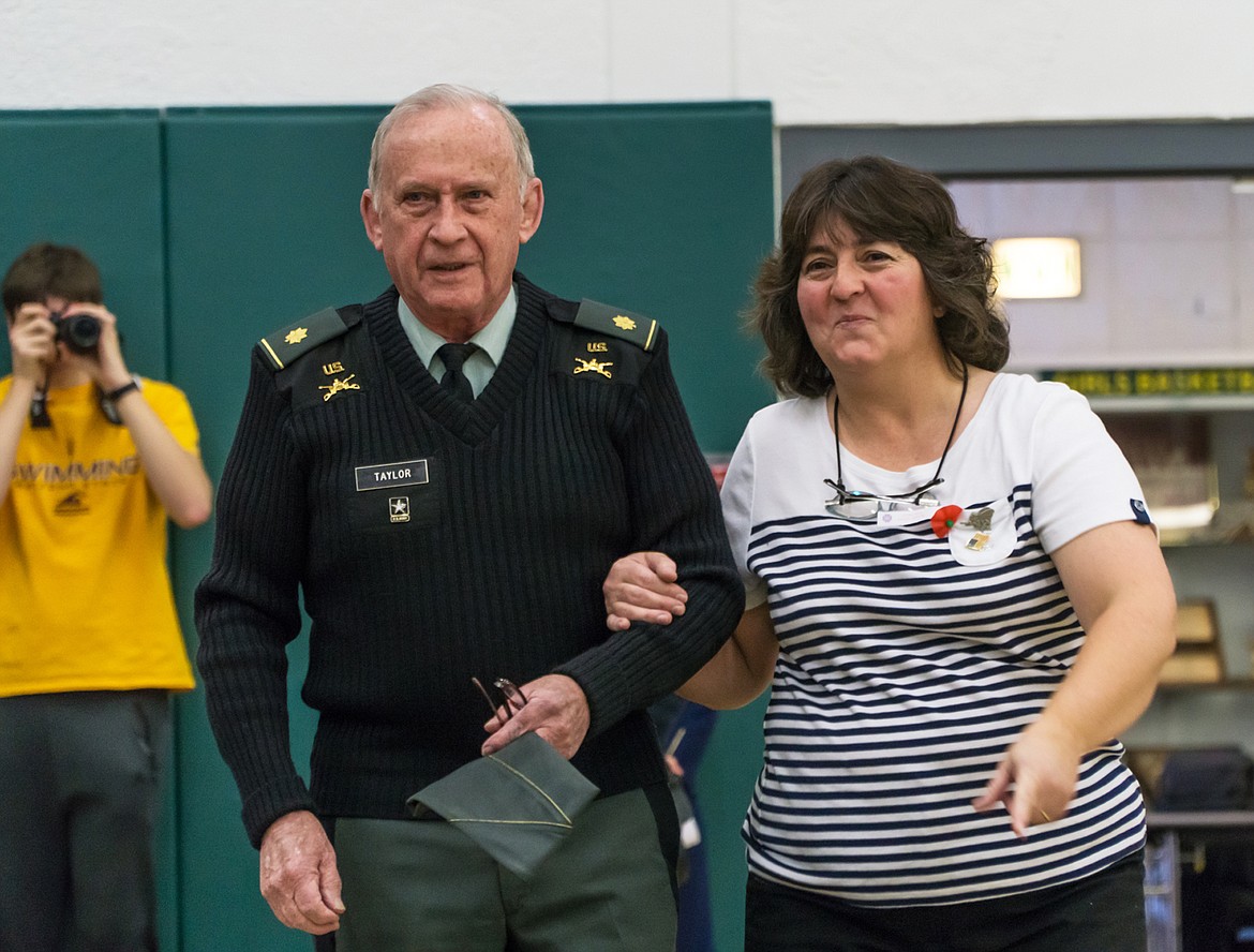 Family and Consumer Sciences teacher Amanda Matdies escorts a veteran to his seat during the Veterans Day celebration on Friday.