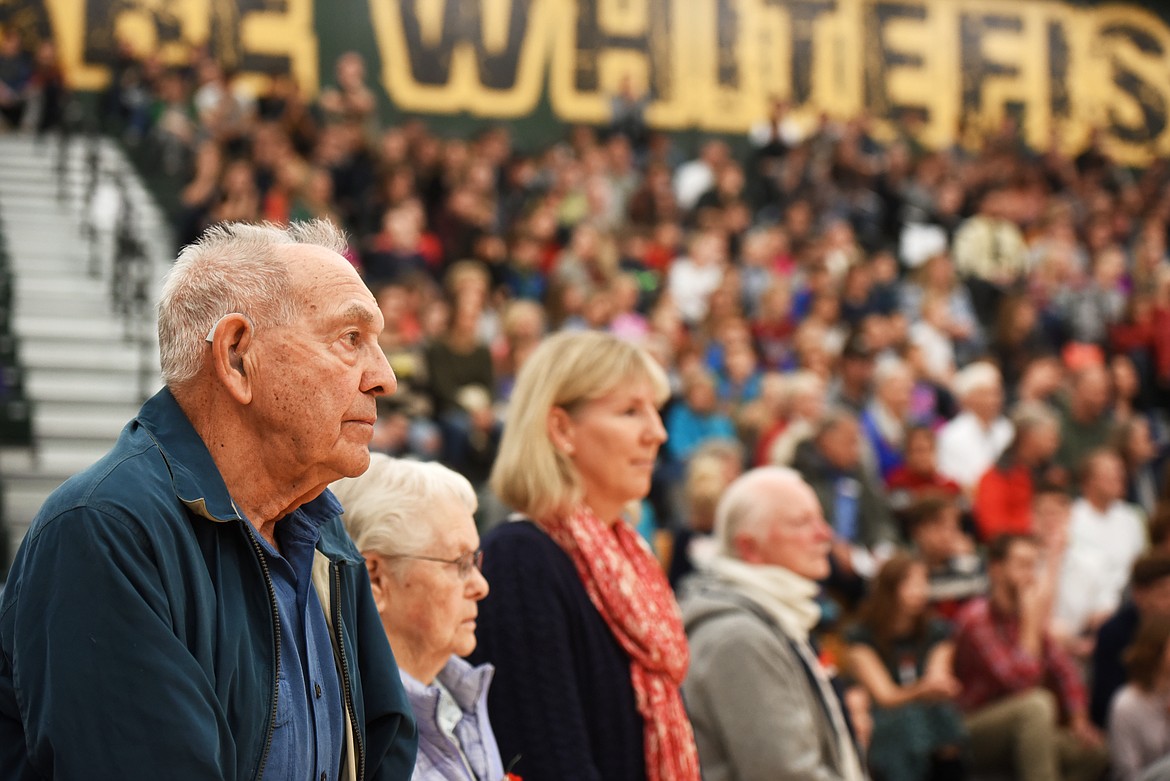 Veteran Bob Olson and his wife Betty and other Navy veterans stand for the playing of Anchors Aweigh during the Veterans Day Community Event at Whitefish High School on Friday, November 10.(Brenda Ahearn/Daily Inter Lake)