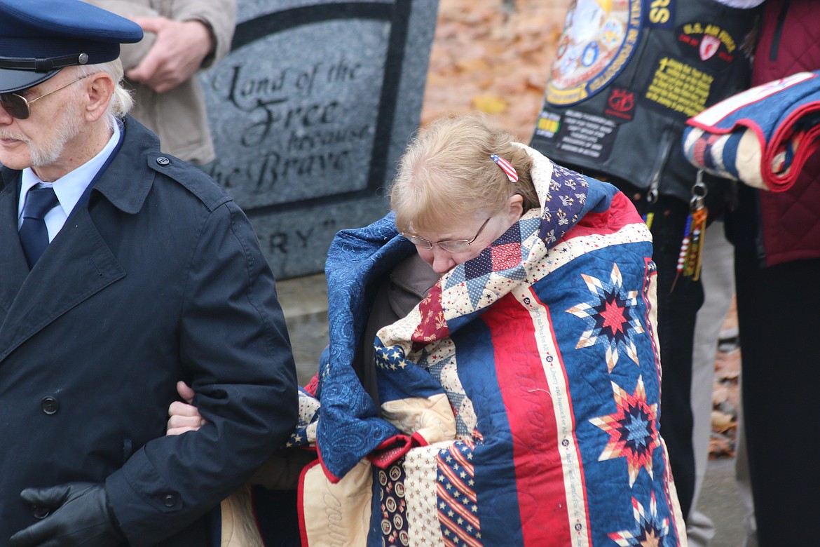 Photo by Mandi Bateman
Wanda Tucker, wrapped in the quilt created by Margaret Pyette, walks back to the audience.