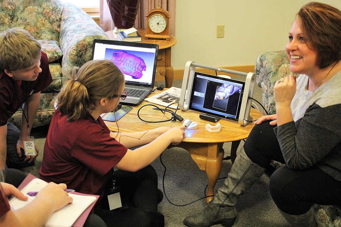 Superior students Emma Hopwood and Howie Edison use a scanner to examine teeth with Erin Woodson of Kenworthy Orthodontics during REACH at the Mineral Community Hospital on Wednesday. (Kathleen Woodford/Mineral Independent).
