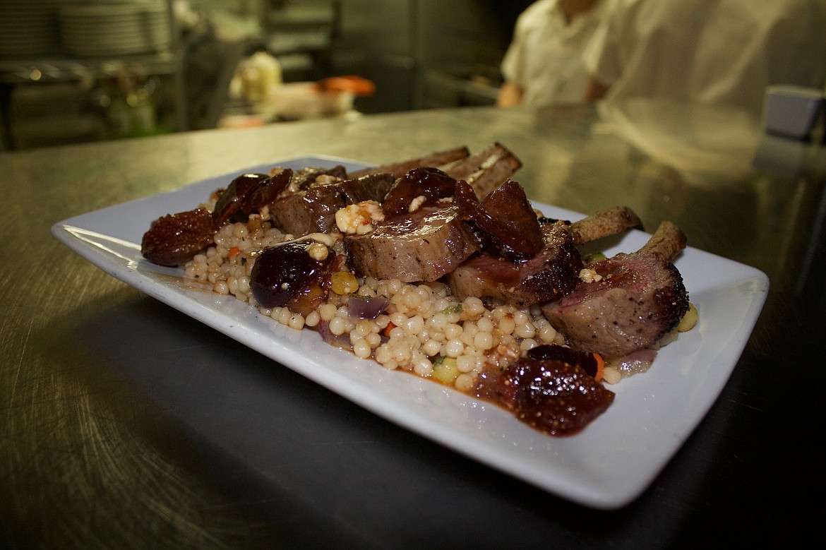 A lamb chop with Israeli couscous, fig, and blue cheese glistens in the kitchen window at The Bluebird.